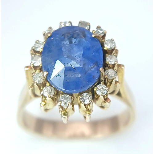 1110 - A 9K Yellow Gold Sapphire Ring. 4ct oval cut central sapphire with a white stone surround. Size K 1/... 