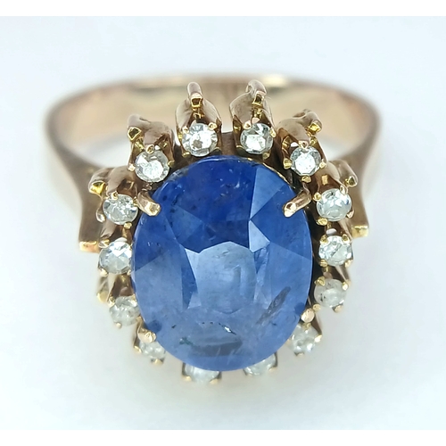 1110 - A 9K Yellow Gold Sapphire Ring. 4ct oval cut central sapphire with a white stone surround. Size K 1/... 