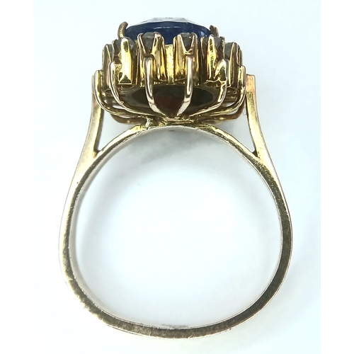 1110 - A 9K Yellow Gold Sapphire Ring. 4ct oval cut central sapphire with a white stone surround. Size K 1/... 