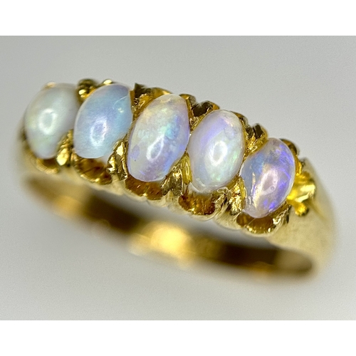 1124 - An 18K Yellow Gold Five Stone Opal Ring. Wonderful colour-play. Size K. 3.1g. NL19/c2205.