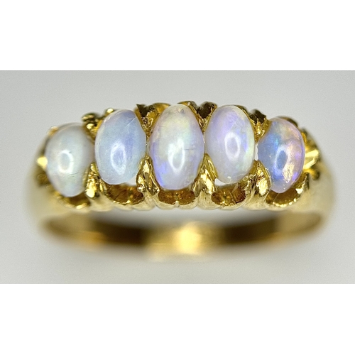 1124 - An 18K Yellow Gold Five Stone Opal Ring. Wonderful colour-play. Size K. 3.1g. NL19/c2205.