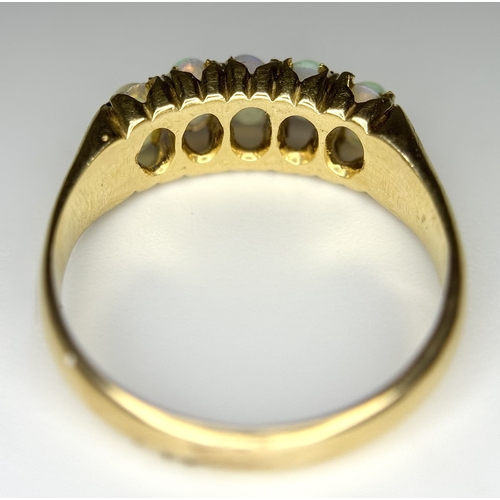 1124 - An 18K Yellow Gold Five Stone Opal Ring. Wonderful colour-play. Size K. 3.1g. NL19/c2205.