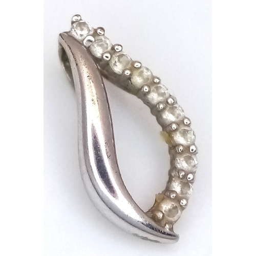 1067 - An 18K Gold (tests as) and Diamond Pendant. 0.5g.