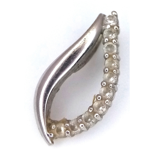 1067 - An 18K Gold (tests as) and Diamond Pendant. 0.5g.