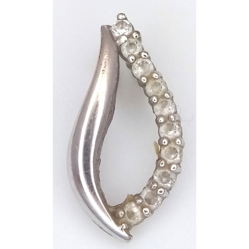 1067 - An 18K Gold (tests as) and Diamond Pendant. 0.5g.