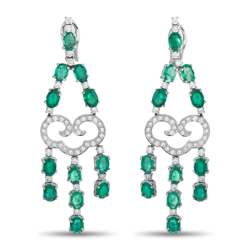 A pair of 18K White Gold 1.50ct Diamond and Emerald Dangle Earrings. Crafted from 18K White Gold, the intricate design is elevated by sparkling Diamonds totaling 1.50 carats. Emeralds with a total weight of 7.0 carats suspended below offer a graceful sense of movement. Each earring measures 2.75 inches long by 0.75 inches wide. In good condition and includes a gift box. Total weight: 23.4 grams. *This item is held at Cadmore USA Office in Pennsylvania, USA and will be shipped from there. Buyers will be responsible for direct shipping payments.*