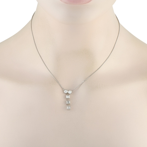 1009 - A Platinum 1.41ct Diamond Necklace. Two bezel-set round diamonds side by side, a vertical drop of th... 