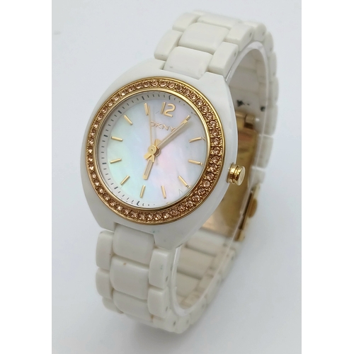 1071 - A DKNY, STONE SET, WHITE WITH GOLD TONE ACCENTS BRACELET WATCH. IN FULL WORKING ORDER. NEW BATTERY F... 