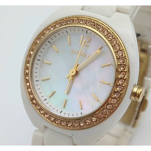 1071 - A DKNY, STONE SET, WHITE WITH GOLD TONE ACCENTS BRACELET WATCH. IN FULL WORKING ORDER. NEW BATTERY F... 