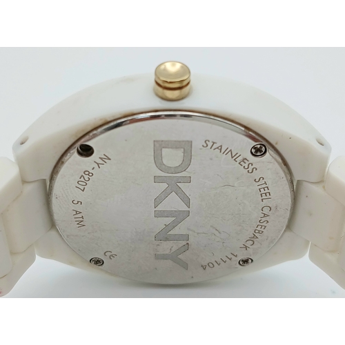 1071 - A DKNY, STONE SET, WHITE WITH GOLD TONE ACCENTS BRACELET WATCH. IN FULL WORKING ORDER. NEW BATTERY F... 