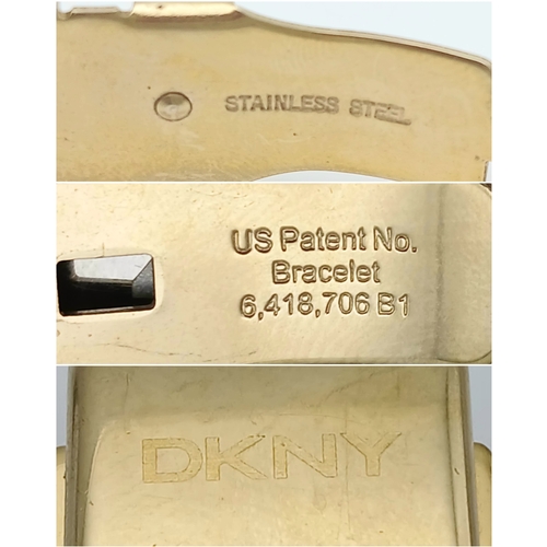 1071 - A DKNY, STONE SET, WHITE WITH GOLD TONE ACCENTS BRACELET WATCH. IN FULL WORKING ORDER. NEW BATTERY F... 