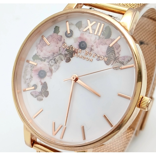 1127 - AN OLIVIA BURTON, ROSE GOLD TONE, MESH BRACELET WATCH WITH FLORAL DIAL. IN FULL WORKING ORDER. S/A 1... 