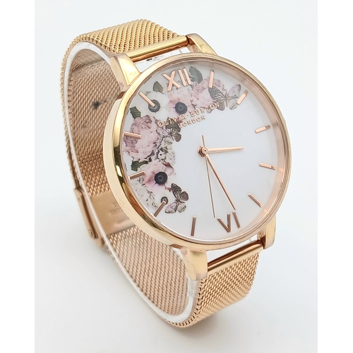1127 - AN OLIVIA BURTON, ROSE GOLD TONE, MESH BRACELET WATCH WITH FLORAL DIAL. IN FULL WORKING ORDER. S/A 1... 