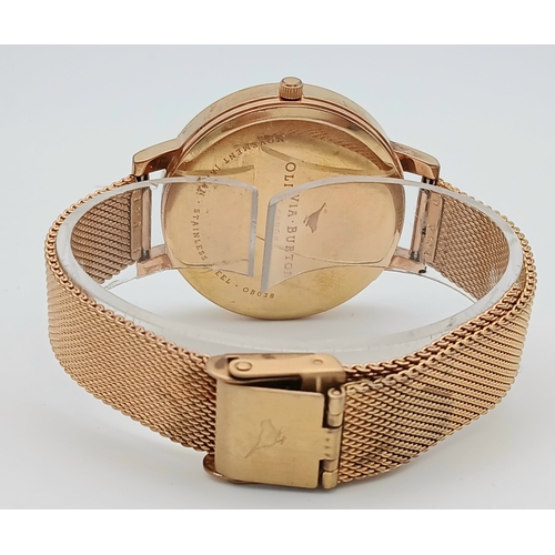1127 - AN OLIVIA BURTON, ROSE GOLD TONE, MESH BRACELET WATCH WITH FLORAL DIAL. IN FULL WORKING ORDER. S/A 1... 