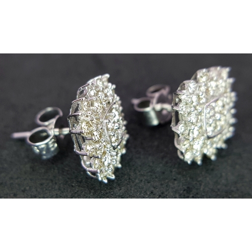 519 - A Pair of 18K White Gold and Diamond Cluster Earrings. c0.50ctw diamonds. 9 x 9mm. 2.21g total weigh... 