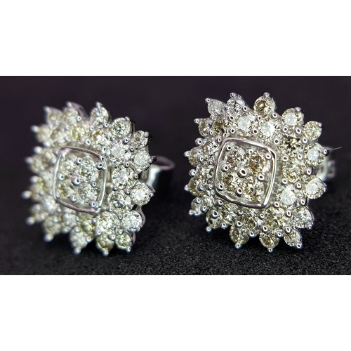 519 - A Pair of 18K White Gold and Diamond Cluster Earrings. c0.50ctw diamonds. 9 x 9mm. 2.21g total weigh... 