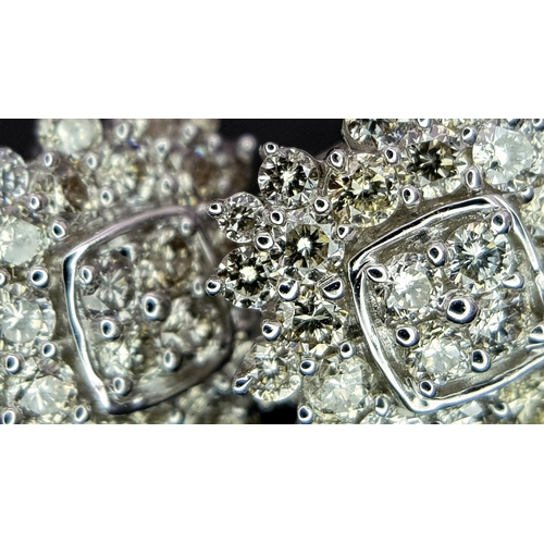 519 - A Pair of 18K White Gold and Diamond Cluster Earrings. c0.50ctw diamonds. 9 x 9mm. 2.21g total weigh... 