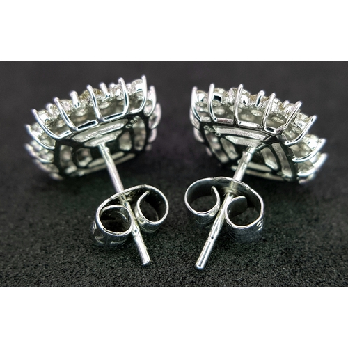 519 - A Pair of 18K White Gold and Diamond Cluster Earrings. c0.50ctw diamonds. 9 x 9mm. 2.21g total weigh... 