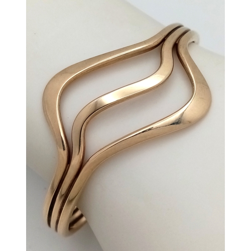 1108 - A 9K Yellow Gold Swirl Cuff Bangle. 22.65g.