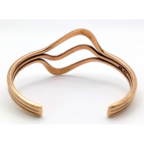 1108 - A 9K Yellow Gold Swirl Cuff Bangle. 22.65g.
