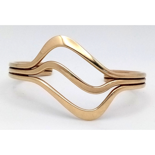 1108 - A 9K Yellow Gold Swirl Cuff Bangle. 22.65g.