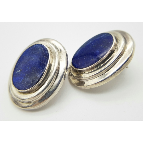 522 - A large pair of 925 silver Oval Lapis Lazuli set clip earrings. Total weight 12.1G.