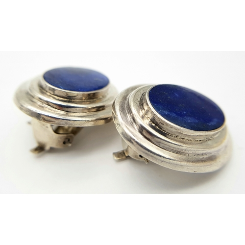 522 - A large pair of 925 silver Oval Lapis Lazuli set clip earrings. Total weight 12.1G.