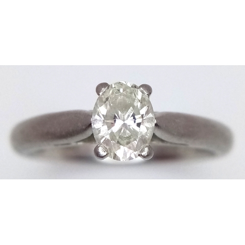 544 - A 950 Platinum, Diamond Solitaire Ring. 0.55ct oval cut diamond. SL2 clarity. Slight colour tint. Si... 