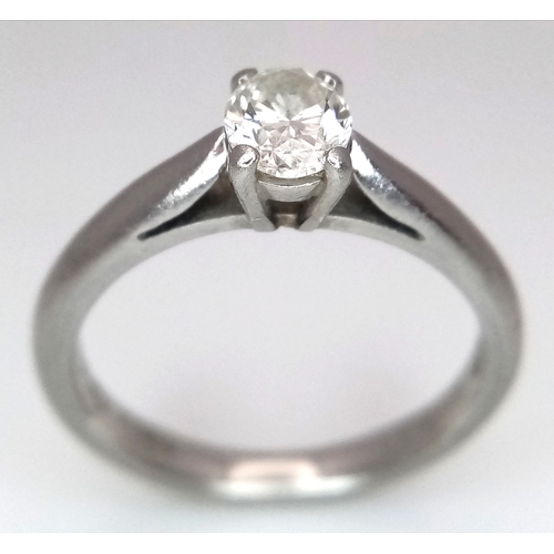 544 - A 950 Platinum, Diamond Solitaire Ring. 0.55ct oval cut diamond. SL2 clarity. Slight colour tint. Si... 