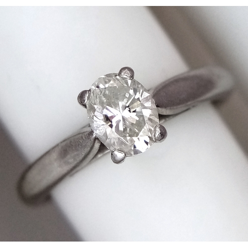 544 - A 950 Platinum, Diamond Solitaire Ring. 0.55ct oval cut diamond. SL2 clarity. Slight colour tint. Si... 