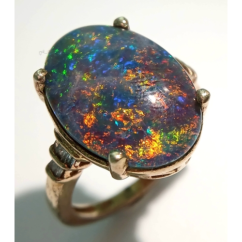 1021 - An Eye-Catching Gold Gilded Opal Set Ring Size M1/2. Set with a 1.8cm Length Opal. Gross weight 4.89... 