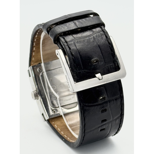 1064 - A DKNY, STONE SET, SQUARE FACE, BLACK LEATHER STRAP WATCH. WITH ORIGINAL STRAP AND BUCKLE. IN FULL W... 