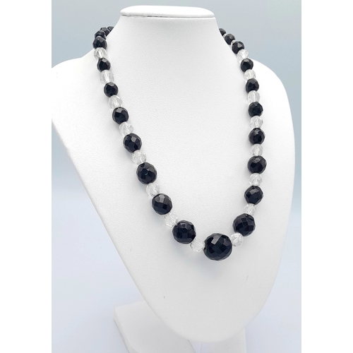1114 - A black and clear faceted bead necklace with 925 silver clasp.
Approx 40cm length. Please see photos... 