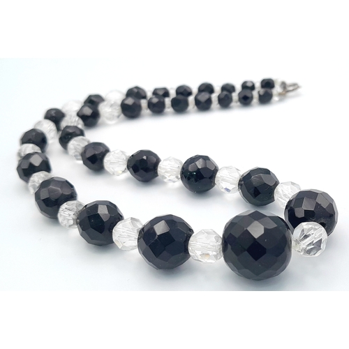 1114 - A black and clear faceted bead necklace with 925 silver clasp.
Approx 40cm length. Please see photos... 