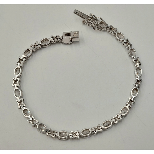 1161 - A Pretty Sterling Silver and Cubic Zirconia Love Bracelet-19cm length. Set with Sixteen 6mm Oval Cut... 