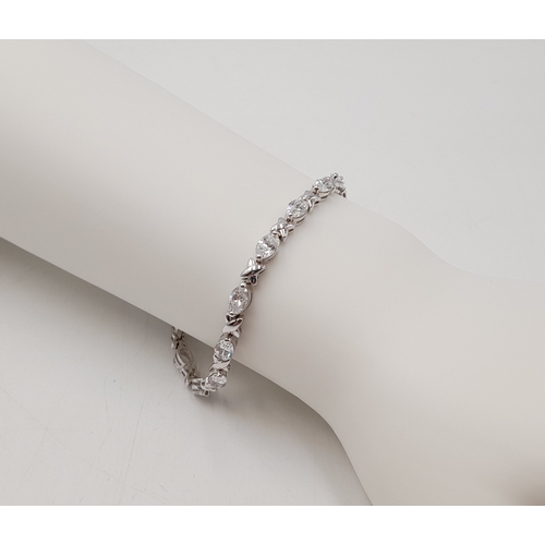1161 - A Pretty Sterling Silver and Cubic Zirconia Love Bracelet-19cm length. Set with Sixteen 6mm Oval Cut... 