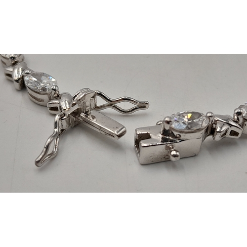 1161 - A Pretty Sterling Silver and Cubic Zirconia Love Bracelet-19cm length. Set with Sixteen 6mm Oval Cut... 