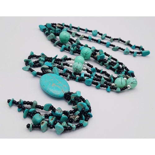 1093 - A pretty turquoise bead necklace. 
Comprising multiple strands of small black beads with turquoise c... 