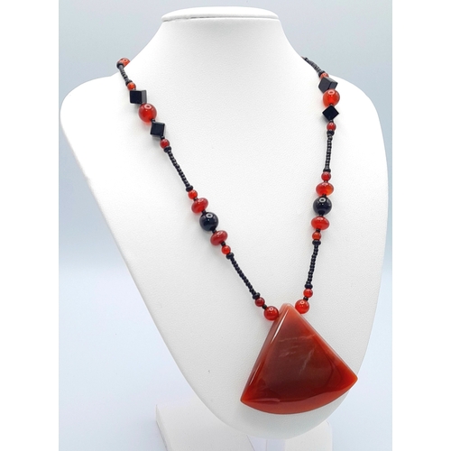 1100 - A red agate and hematite necklace with 925 silver clasp.
Approx 50cm length. Please see photos for d... 