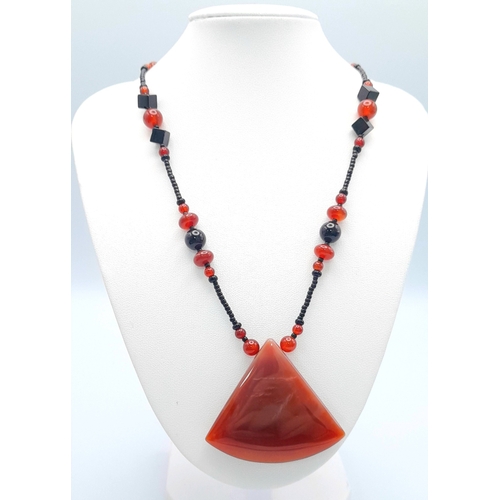 1100 - A red agate and hematite necklace with 925 silver clasp.
Approx 50cm length. Please see photos for d... 