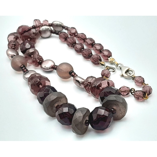 1107 - A purple and brown mixed stone bead necklace with 925 silver clasp. Approx 49cm length. Please see p... 