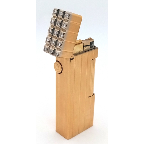 A Highly Collectible Vintage Alfred Dunhill 18K Gold Outer Jacket and Diamond Cased Rollagas Lighter. Vertical fluted pattern. 15 round brilliant cut set diamonds. Not currently working, probably in need of a service but still a fantastic piece. 6.5cm tall. 114g total weight. UK Mainland shipping Only
