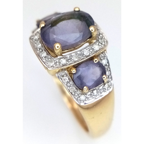 148 - A 9K Yellow Gold Diamond and Amethyst Cocktail Ring. Three oval cut amethysts with diamond surrounds... 