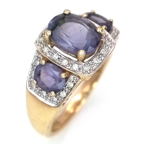 148 - A 9K Yellow Gold Diamond and Amethyst Cocktail Ring. Three oval cut amethysts with diamond surrounds... 