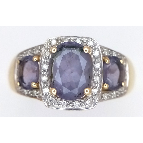 148 - A 9K Yellow Gold Diamond and Amethyst Cocktail Ring. Three oval cut amethysts with diamond surrounds... 
