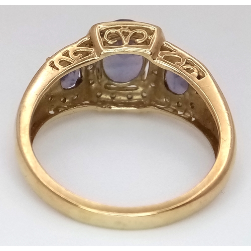 148 - A 9K Yellow Gold Diamond and Amethyst Cocktail Ring. Three oval cut amethysts with diamond surrounds... 
