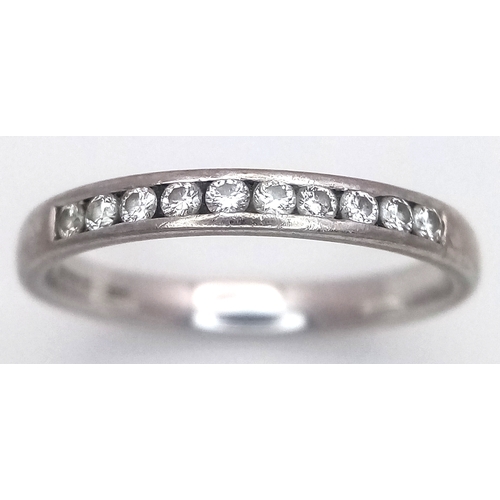 183 - An 18K White Gold Diamond Channel Set Ring. 10 diamonds - 0.20ctw. Size J 1/2. 2.1g.