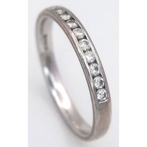 183 - An 18K White Gold Diamond Channel Set Ring. 10 diamonds - 0.20ctw. Size J 1/2. 2.1g.