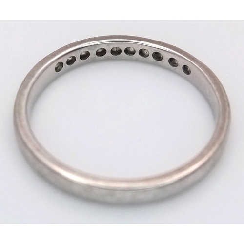 183 - An 18K White Gold Diamond Channel Set Ring. 10 diamonds - 0.20ctw. Size J 1/2. 2.1g.