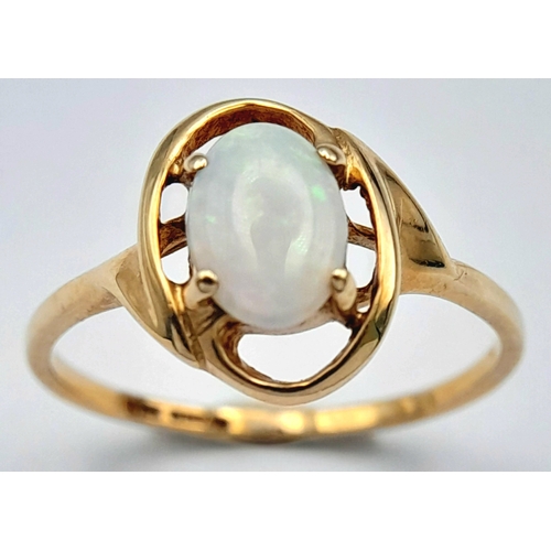 365 - A 9K Yellow Gold Opal Solitaire Ring. Cabochon stone with good colour play. Size J 1/2. 1.4g.
